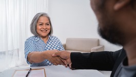 Dentures patient in Wakefield shaking hands with a client