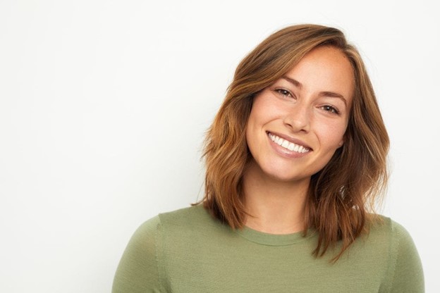 20-something person with dentures smiling